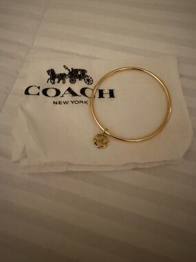 Coach Gold Tone Slim  Bangle with Signature Carriage Charm and Dustbag